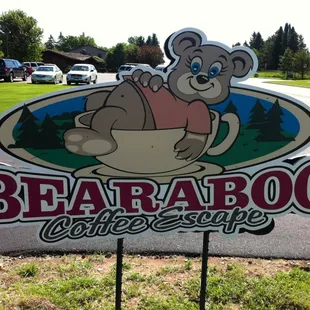 a bear holding a cup of coffee