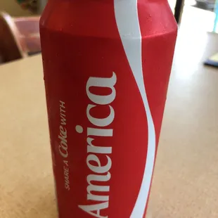 a can of coke on a table