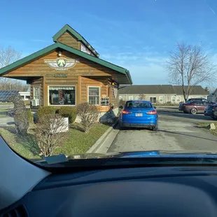 a blue car parked in front of a building