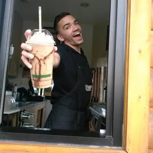 a man holding a cup of coffee