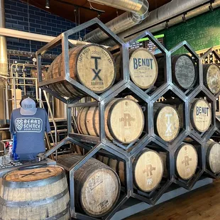 a man standing in front of barrels