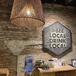 a brick wall with a sign that says local drink local