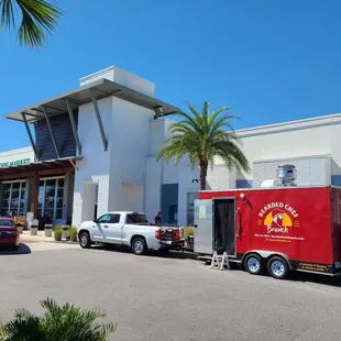 a food truck parked in front of a restaurant