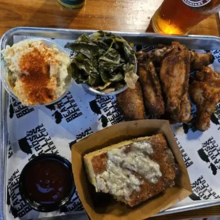 Wings, cornbread, greens, potato salad.