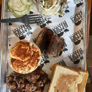 Brisket, pork belly, toast, potato salad, slaw, and pickles.
