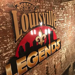a brick wall with a sign that says louisville legends
