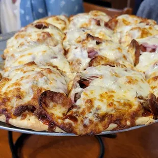 a pizza with ham and cheese