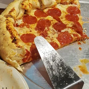 a half eaten pepperoni pizza