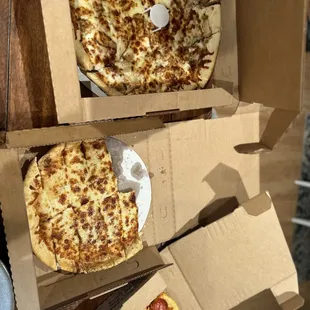 two pizzas in boxes