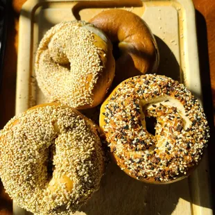 a variety of bagels on a tray