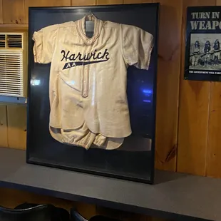 an old baseball jersey in a display case