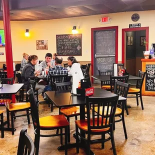 people sitting at tables in a restaurant