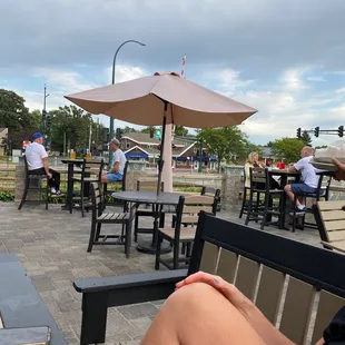 a woman sitting on a bench with a drink in her hand