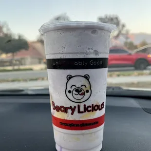 a cup of coffee on the dashboard of a car