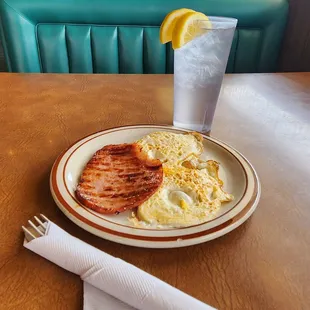 Two eggs &amp; a slice of ham that came with biscuits &amp; gravy plate.