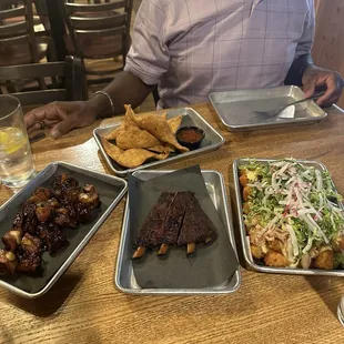 Pork candy, The Chris Rock (just one rib), brisket wonton, and the chicken tachos.