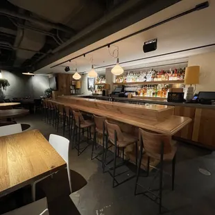 a bar with stools and tables