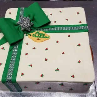 a gift wrapped in white frosting with a green bow
