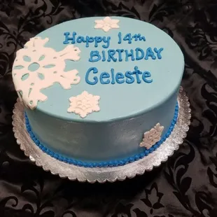 a blue and white birthday cake