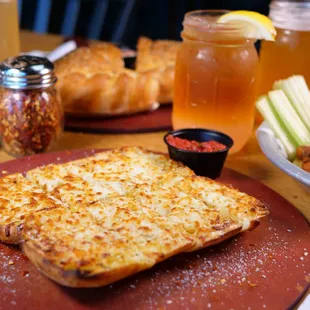 a plate of pizza and other food items