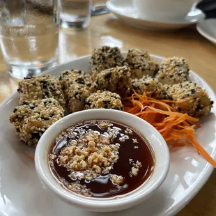 a plate of food with dipping sauce