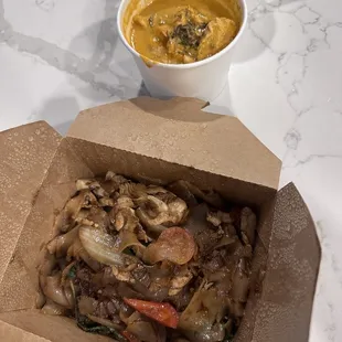 a bowl of soup and a box of noodles