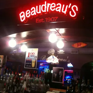 a neon sign above the bar