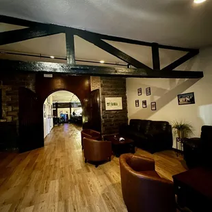 a wood floor and leather chairs