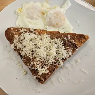 a piece of toast and eggs on a plate