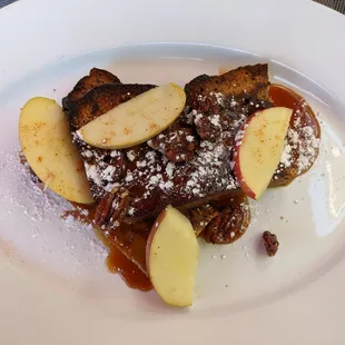 Fantastic baked French toast tasted like bread pudding with apple slices and roasted pecans, with a thick caramel sauce.