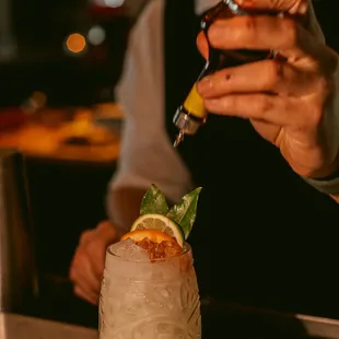 a man preparing a cocktail