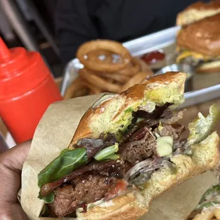 a hand holding a sandwich