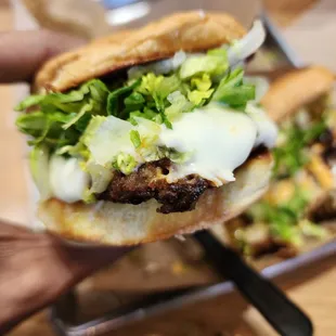 a hand holding a sandwich