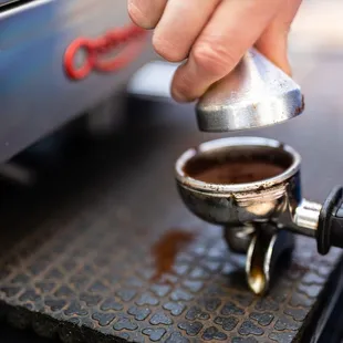 a person making a cup of coffee