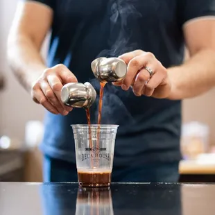 a man pouring coffee into a cup