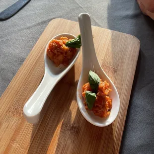 two spoons on a cutting board