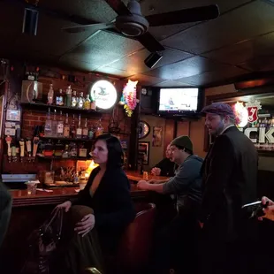 a group of people sitting at a bar