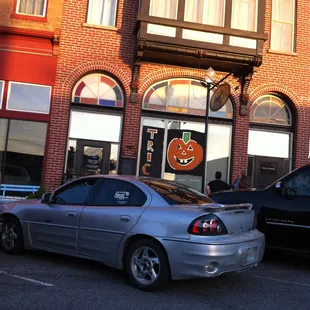 two cars parked in front of a brick building