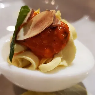 an egg with sauce and garnish