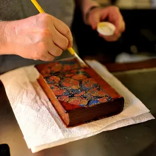 The proprietor doing some care on the leather of an old volume