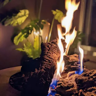 a fire pit with logs and flames