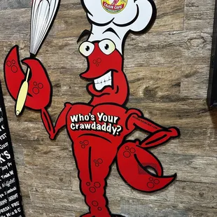 a lobster holding a whisk