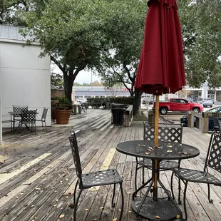 a patio with tables and chairs