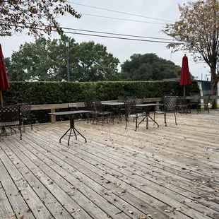 a deck with chairs and umbrellas