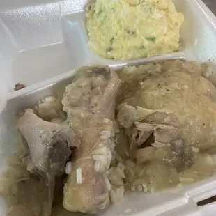 Stewed chicken with rice and gravy, potato salad.