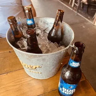 a bucket full of beer bottles