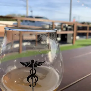 a glass of beer sitting on a table