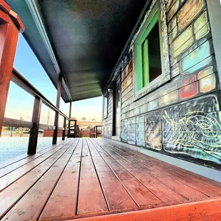 a wooden porch with graffiti on it