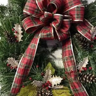 a christmas wreath on a brick wall