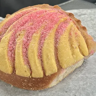 a pastry with pink and yellow icing